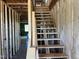 Interior view of staircase under construction; framing shows open floor plan with natural light at 101 Parkland Dr, Pittsboro, NC 27312