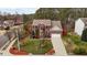 Aerial view of a brick home with well-kept lawn and landscaping, long driveway, and 2-car garage at 1046 Upchurch Farm Ln, Cary, NC 27519