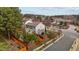 This aerial view shows a house with a fenced backyard, mature trees, and a view of a pond at 1046 Upchurch Farm Ln, Cary, NC 27519
