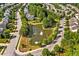 Neighborhood pond with a fountain surrounded by a variety of homes and lush greenery at 1046 Upchurch Farm Ln, Cary, NC 27519