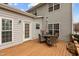 The wooden back deck provides a great entertaining space with a patio set and room for grilling at 1046 Upchurch Farm Ln, Cary, NC 27519
