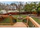 The backyard with fencing has a stone planting bed with a statue, garden beds and level lawn at 1046 Upchurch Farm Ln, Cary, NC 27519