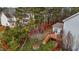 Aerial view of the backyard showing a deck, mature trees, and a privacy fence at 1046 Upchurch Farm Ln, Cary, NC 27519