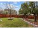 The backyard is fully fenced with garden beds and mature trees to offer maximum privacy at 1046 Upchurch Farm Ln, Cary, NC 27519