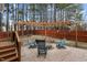 Backyard features a pergola over a fire pit, surrounded by Adirondack chairs, all within a fenced area at 1046 Upchurch Farm Ln, Cary, NC 27519