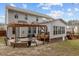 This backyard has a stone patio with a fire pit and adjoins a sunroom with plenty of natural light at 1046 Upchurch Farm Ln, Cary, NC 27519