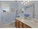 Bathroom features a double vanity, large mirror, tiled floor, and coordinated accessories at 1046 Upchurch Farm Ln, Cary, NC 27519