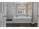 Bathroom showcases a soaking tub with a tiled surround, a glass-enclosed shower, and decorative finishes at 1046 Upchurch Farm Ln, Cary, NC 27519
