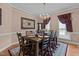 Formal dining room with a large wooden table, chandelier, and elegant decor at 1046 Upchurch Farm Ln, Cary, NC 27519