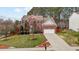 Charming two-story brick home with a well-manicured lawn and attached two-car garage at 1046 Upchurch Farm Ln, Cary, NC 27519
