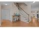 Foyer with a staircase, table and decorations and hardwood floors at 1046 Upchurch Farm Ln, Cary, NC 27519