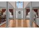 Elegant foyer with hardwood floors, columns, high ceiling, and a grand front door at 1046 Upchurch Farm Ln, Cary, NC 27519