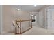 Hallway with carpeted floors, white railing, and open doorways to bedrooms at 1046 Upchurch Farm Ln, Cary, NC 27519