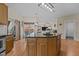 Kitchen boasts an island, wood cabinets and flows into dining and living room at 1046 Upchurch Farm Ln, Cary, NC 27519