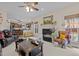 Cozy living room featuring a fireplace, ceiling fan, and view to kitchen at 1046 Upchurch Farm Ln, Cary, NC 27519