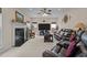 Spacious living room with a fireplace, large television, comfortable seating, and neutral decor at 1046 Upchurch Farm Ln, Cary, NC 27519