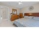 Bedroom with a decorative bed, dresser, and a mirror with a gold decorative figure in the background at 1046 Upchurch Farm Ln, Cary, NC 27519