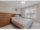 Bedroom featuring a decorative bed, dresser, chest of drawers, and large window providing natural light at 1046 Upchurch Farm Ln, Cary, NC 27519