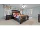 Main bedroom featuring large bed, elegant curtains, and ensuite bathroom at 1046 Upchurch Farm Ln, Cary, NC 27519