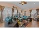 Bright sunroom with wicker furniture, ceiling fan, and large windows for natural light at 1046 Upchurch Farm Ln, Cary, NC 27519