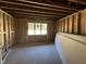 Unfinished basement with exposed wood framing and a window for natural light at 107 Parkland Dr, Pittsboro, NC 27312
