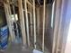 Unfinished basement walls with stud framing, wiring, and pipes at 107 Parkland Dr, Pittsboro, NC 27312