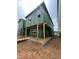 Two-story home under construction with visible frames and windows, showcasing the construction process and outdoor patio at 107 Parkland Dr, Pittsboro, NC 27312