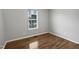 Bedroom with hardwood flooring, fresh paint and window at 108 New Castle Ct, Youngsville, NC 27596