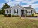 Charming home featuring a landscaped yard, gray siding, black shutters, and a welcoming entrance at 108 New Castle Ct, Youngsville, NC 27596