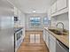 Bright kitchen featuring white cabinetry, granite countertops, stainless appliances, and modern backsplash at 108 New Castle Ct, Youngsville, NC 27596