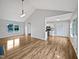 Bright living room that opens to the kitchen area with updated light fixtures and a vaulted ceiling at 108 New Castle Ct, Youngsville, NC 27596