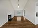 Bright, airy living room with a fireplace, vaulted ceiling, and light wood floors at 108 New Castle Ct, Youngsville, NC 27596