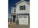 New construction home with gray siding, white garage door, and stone accents on the lower level at 11 Silver Pne Dr, Angier, NC 27501