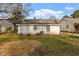 Backyard featuring a house with dual windows, an AC unit, and healthy green grass at 1103 Gaston St, Smithfield, NC 27577