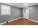 Comfortable bedroom featuring wood floors, a window and a white wooden door at 1103 Gaston St, Smithfield, NC 27577