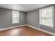 Bright bedroom with hardwood floors, gray walls, and natural light from two windows at 1103 Gaston St, Smithfield, NC 27577