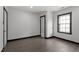 Clean bedroom with hardwood floors, light walls, and a window at 1103 Gaston St, Smithfield, NC 27577