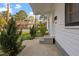 Inviting front porch featuring freshly painted white exterior, green shrubs, and leading to a well-maintained yard at 1103 Gaston St, Smithfield, NC 27577