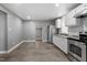 Modern kitchen with stainless steel appliances, white cabinets, and updated countertops adjacent to a dining area at 1103 Gaston St, Smithfield, NC 27577