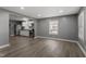 Bright living room featuring recessed lighting, gray walls, and new wood laminate flooring adjacent to the kitchen at 1103 Gaston St, Smithfield, NC 27577