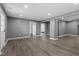 Spacious living room offers recessed lights, neutral gray walls, and wood laminate flooring, leading to other rooms at 1103 Gaston St, Smithfield, NC 27577