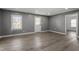 Bright living room showcases a large window, fresh gray paint, new flooring, and great natural light at 1103 Gaston St, Smithfield, NC 27577