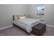 Cozy bedroom with large window, carpet flooring, and a small bed with an ottoman at 1176 Andrews Ct, Creedmoor, NC 27522