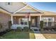 Inviting front porch with an American flag and a white picket fence creates curb appeal at 1176 Andrews Ct, Creedmoor, NC 27522