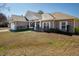 Charming brick home with a welcoming front porch and manicured lawn under a clear blue sky at 1176 Andrews Ct, Creedmoor, NC 27522