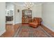 Well-lit living room showcases a chandelier, a leather chair, and a hutch cabinet at 1176 Andrews Ct, Creedmoor, NC 27522
