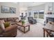 Spacious living room with natural light, comfortable seating, and a cozy fireplace at 1176 Andrews Ct, Creedmoor, NC 27522
