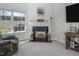 Cozy living room with a fireplace, large windows, and views of the backyard at 1176 Andrews Ct, Creedmoor, NC 27522