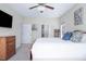 Main bedroom featuring a dresser, ceiling fan and two doors to a closet and bathroom at 1176 Andrews Ct, Creedmoor, NC 27522