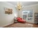 Bright office space with a chandelier, a cozy couch and large windows offering plenty of natural light at 1176 Andrews Ct, Creedmoor, NC 27522